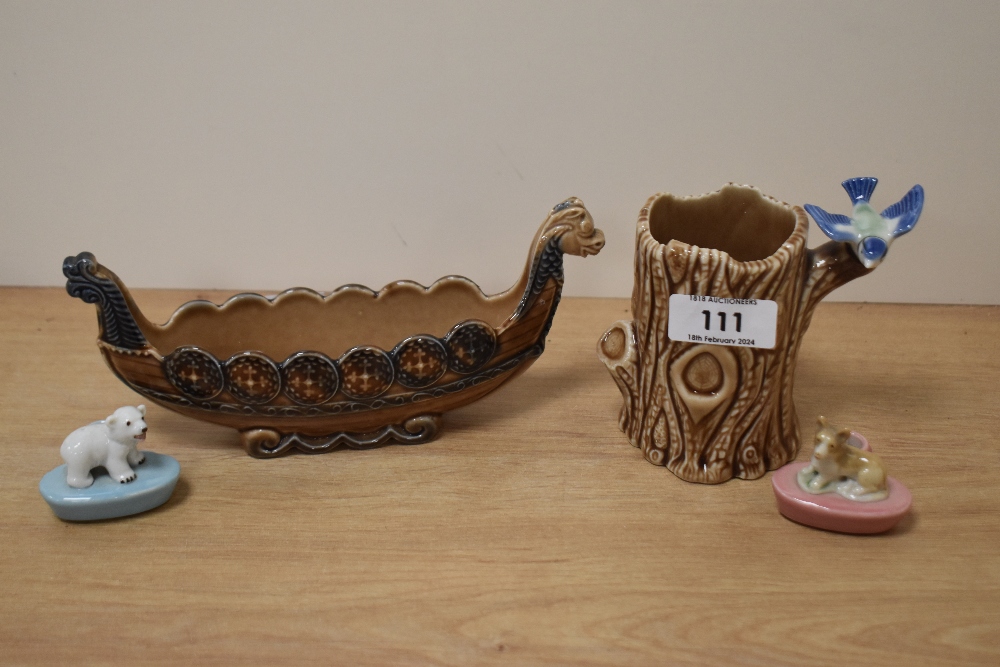 A wade Viking ship and tree trunk spill vase with bluebird and two Wade pencil holders, one with dog