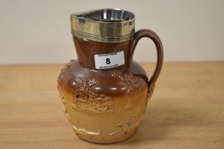 A 19th Century stoneware harvest jug, of Doulton Lambeth style, with silver coloured rim,