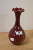 A 20th Century W & Co. Vase, on red ground, with crimped rim, and measuring 21cm tall, incised marks