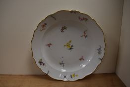 A 19th/20th Century porcelain charger, having Meissen crossed sword marks to the underside, hand