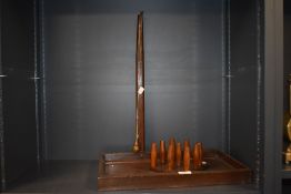 A vintage wooden table skittles game, comprising nine skittles, measuring 56cm tall