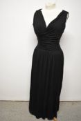 A late 1950s / early 1960s black evening gown of Grecian style, having 'Cresta' label, side zip,