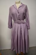An American 1950s pure silk lavender coloured day dress, having pleated skirt, tucks to rear of