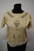 An early 1900s cream silk blouse having beautiful detail and embroidery throughout, for study,