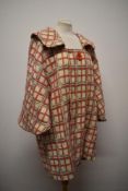 A late 1950/1960s cream wool swing coat, having pink, beige and white checked pattern, portrait
