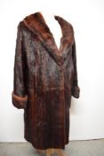 A mahogany coloured mink coat having turn up cuffs.