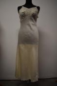 A 1930s bias cut cream silk nightdress or full length slip, having crepe accents, tulle and