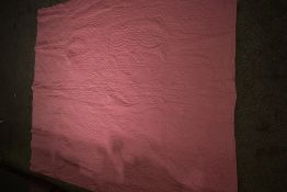 An early 20th century hand stitched Durham quilt, having block rose pink to one side and floral