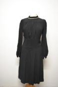 A 1930s black crepe day dress, having pleated bust gathering into a fitted waist and cream accent to