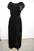 A late 1930s black velvet evening dress with shawl collar and metal side zip.