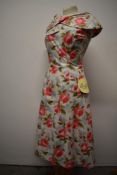 A stunning 1950s dead stock Mary Jane of London cotton day having bold pink rose pattern on pale