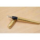 A boxed S T Dupont Fidelio gold plated cartridge fountain pen having 14k Dupont nib