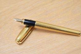 A boxed S T Dupont Fidelio gold plated cartridge fountain pen having 14k Dupont nib