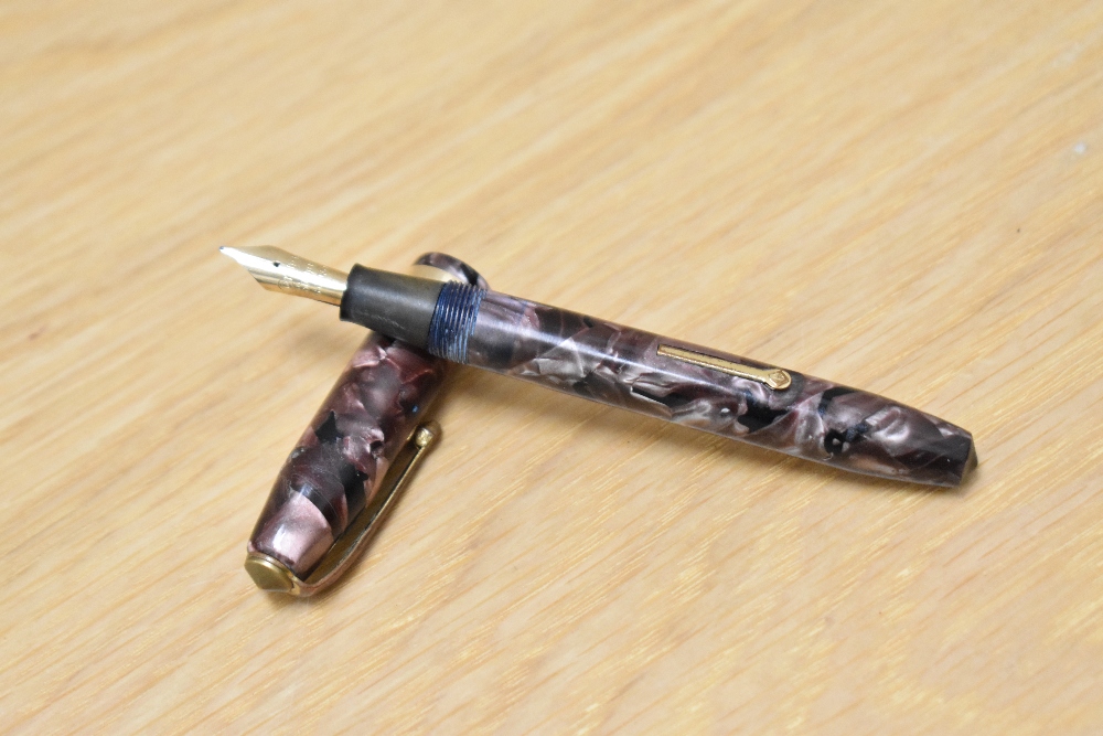 A Conway Stewart 84 lever fill fountain pen in rose marble with single broad band to cap having