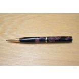 A Parker Duofold propelling pencil in burgundy and black marble. Missing top and engraved