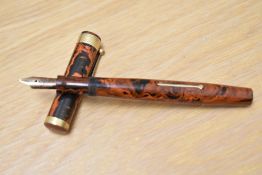 A Mabie Todd Swan Eternal lever fill fountain pen in red black HR with broad band to base of the cap