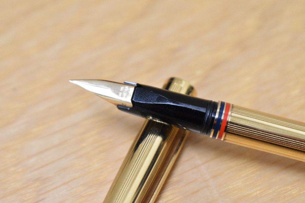 A boxed Caran d'Ache Ambassador converter/ cartridge fill fountain pen, gold plated with red and - Image 2 of 3