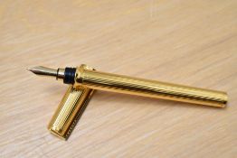 A boxed S T Dupont Montparnasse converter fountain pen gold plated reeded design having 18k Dupont