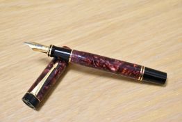 A Parker Duofold Centennial MKI converter fill fountain pen in maroon marble with one narrow and one