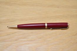 A Parker Duofold propelling pencil in red with decorative band