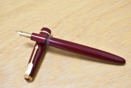 A Parker Duofold aero fill fountain pen in red with narrow decorative band to the cap having