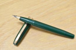 A Sheaffer Imperial III plunger fill fountain pen in green having broad band to base of the cap