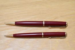 Two Parker Duofold propelling pencils in red with decorative band