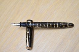 A Parker Vacumatic fountain pen in golden brown with broad band to the cap and blue diamond clip