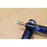 A Conway Stewart Dinkie 550 lever fill fountain pen in Blur/bronze marble with single band to the