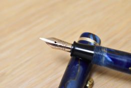 A Conway Stewart Dinkie 550 lever fill fountain pen in Blur/bronze marble with single band to the