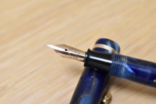 A Conway Stewart Dinkie 550 lever fill fountain pen in Blur/bronze marble with single band to the