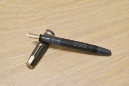 A Parker Duofold button fill fountain pen in grey with decorative band to the cap having Parker