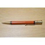 A Parker Duofold propelling pencil in red with black band to top and bottom of the barrel