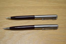 Two Parker propelling pencils in burgundy on with liquid lead cartridge