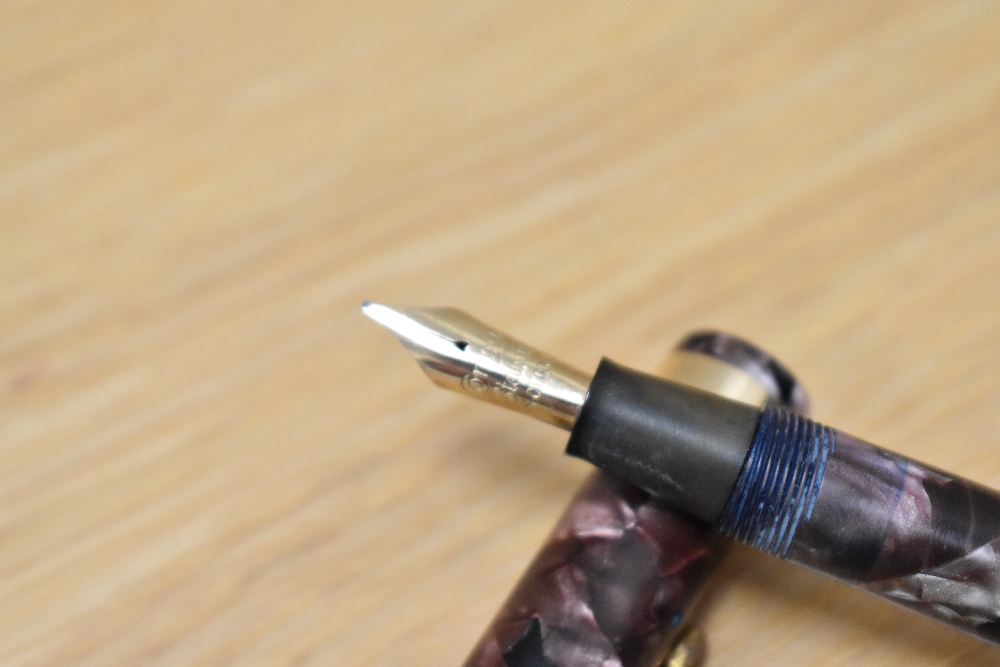 A Conway Stewart 84 lever fill fountain pen in rose marble with single broad band to cap having - Image 3 of 3