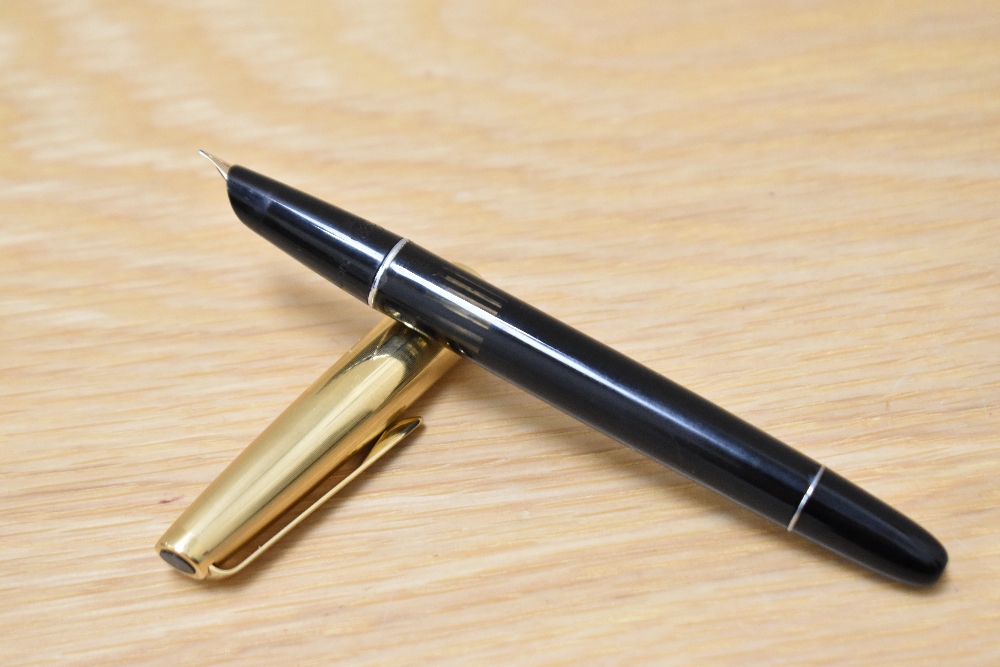 An Aurora 88P piston fill fountain pen in black with gold cap