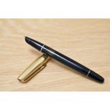 An Aurora 88P piston fill fountain pen in black with gold cap