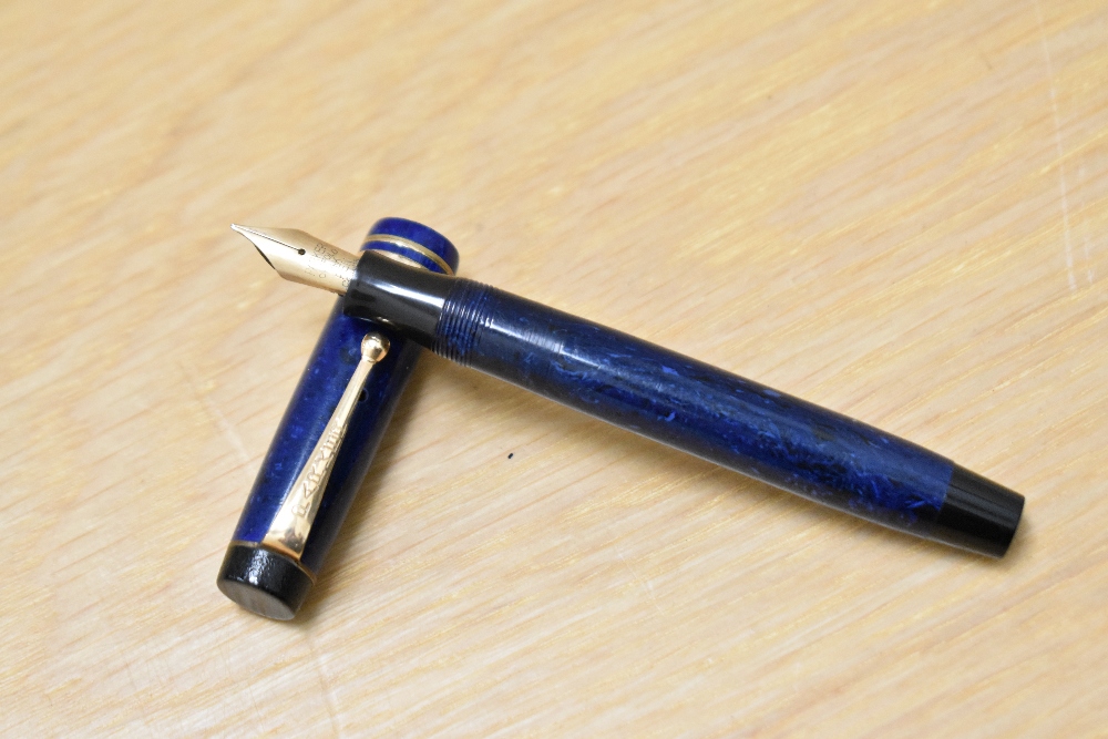A Parker Streamlined Duofold button fill fountain pen in Lapis blue with two bands to the cap having