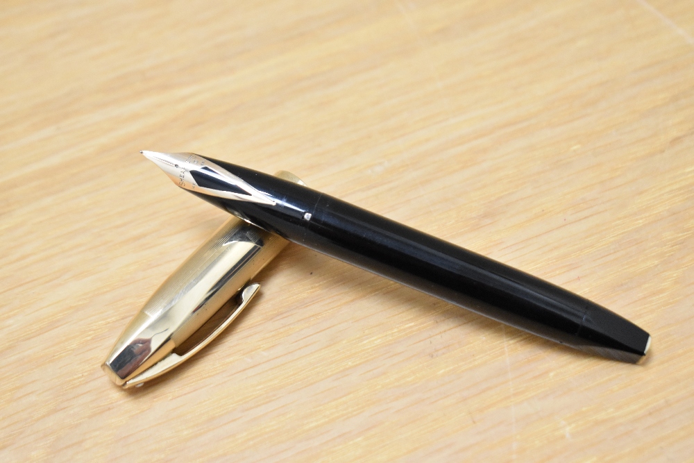 A Sheaffer Pen for Men V snorkel fill fountain pen in black with a rolled gold cap having a Sheaffer