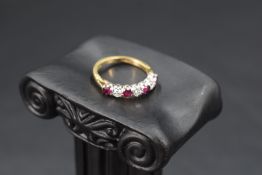 A seven stone ruby and diamond half eternity ring, each stone approx 0.064ct in a claw set mount