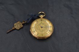 A small 18ct gold key wound pocket watch having Roman numeral dial to decorative face in engraved