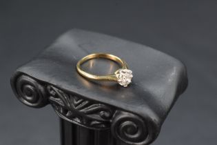 A diamond solitaire ring, approx 0.6ct in a raised claw set mount on a yellow metal loop, no