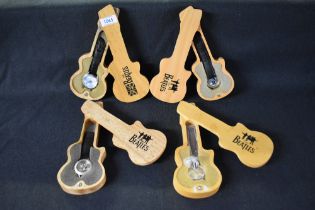 Four Beatles themed fashion wrist watches, all having decorative faces in wooden guitar shaped