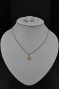 A 9ct gold pearl pendant on a yellow metal chain, presumed gold, with a pair of matched 9ct gold