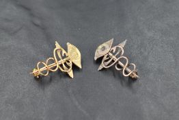 A small 18ct gold Caduceus brooch having an Eye terminal, approx 2.4g and a matching silver