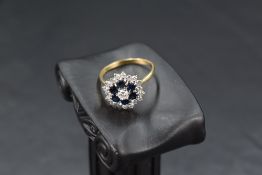 A sapphire and diamond triple daisy cluster ring having central brilliant cut diamond approx 0.