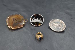 Three brooches including agate in yellow metal mount, tortoise shell with silver frigate