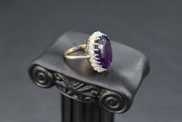 An amethyst and diamond oval cluster ring having large oval amethyst, approx 12ct surrounded by
