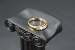 A seven stone diamond eternity ring, total approx 0.35ct in a channel set mount on a yellow metal