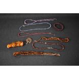 A selection of strings of beads including Baltic amber, rough cut amethyst and garnet, baltic